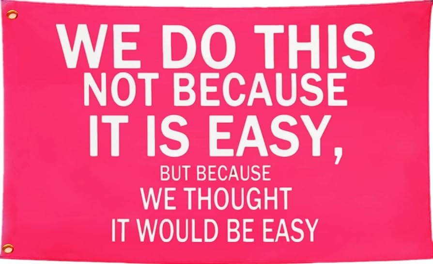 Sign that sayd "We do this not because it is easy, but because we thought it would be easy.